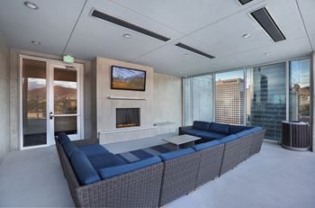 Rooftop lounge with fireplace and blue sofas